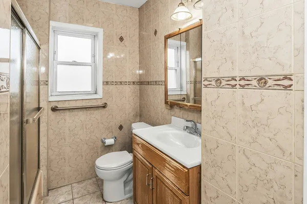 a bathroom with a sink toilet and shower