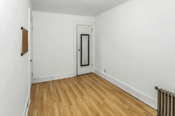 an empty room with a hardwood and a sink