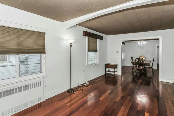 a dining room with furniture and wooden floor