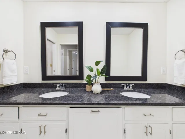 a bathroom with double sink sinks and a mirror