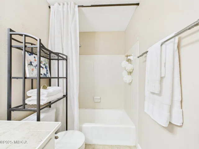 a bathroom with a bathtub and shower