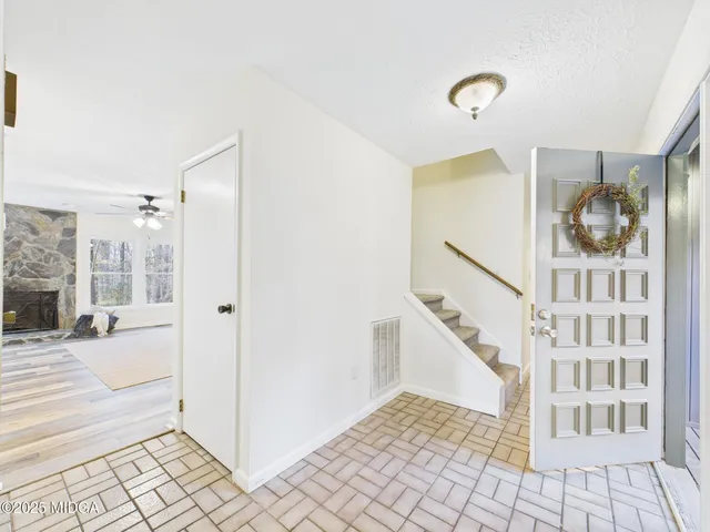 a view of a hallway with windows and stairs