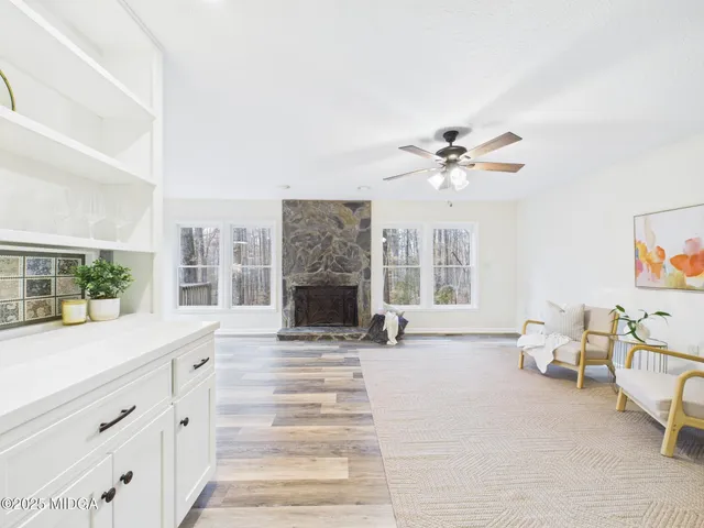 a view of a livingroom with furniture staircase and a fireplace
