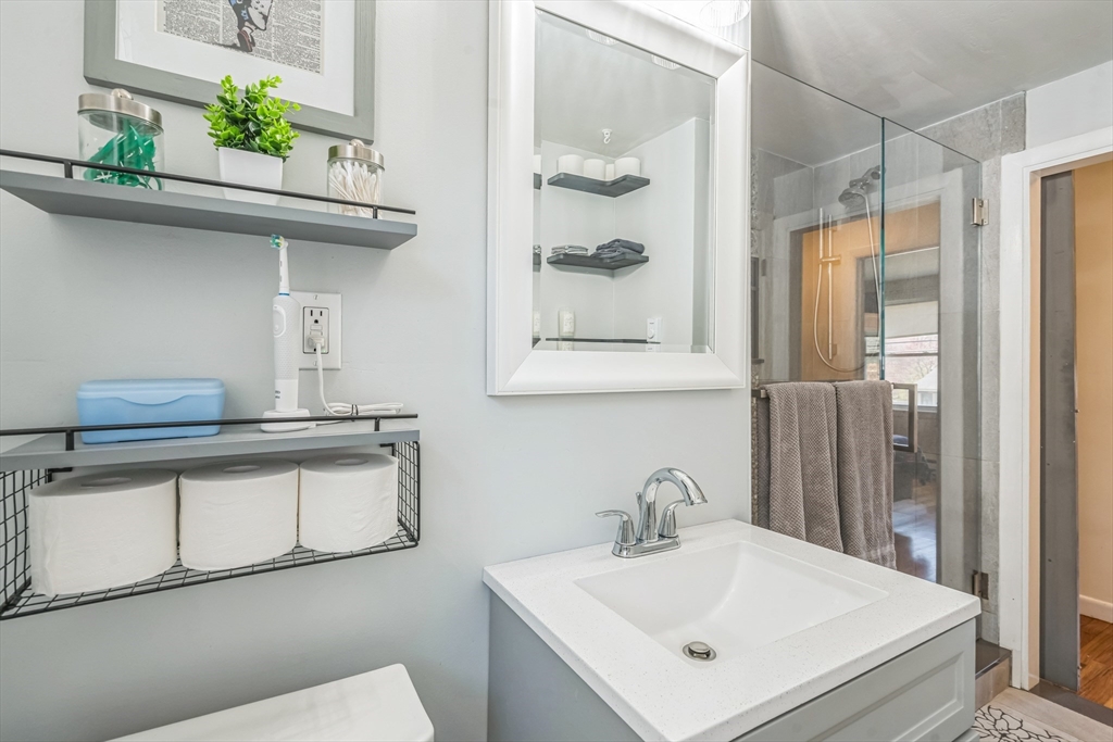 156 Andover Road Billerica, MA 01821 - Photo 11 of 22 a bathroom with a sink a mirror and a toilet