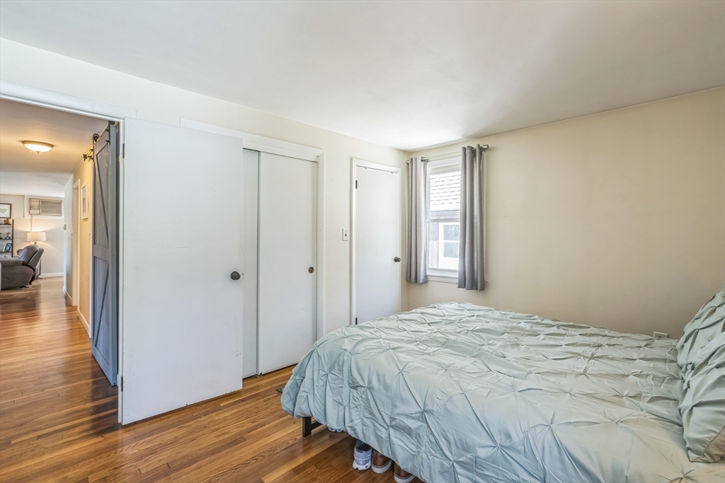 156 Andover Road Billerica, MA 01821 - Photo 15 of 22 a bedroom with a bed and wooden floor