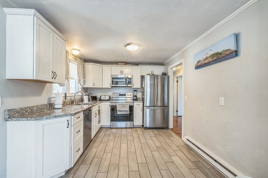 156 Andover Road Billerica, MA 01821 - Photo 5 of 22 a kitchen with stainless steel appliances granite countertop a stove a sink and a refrigerator
