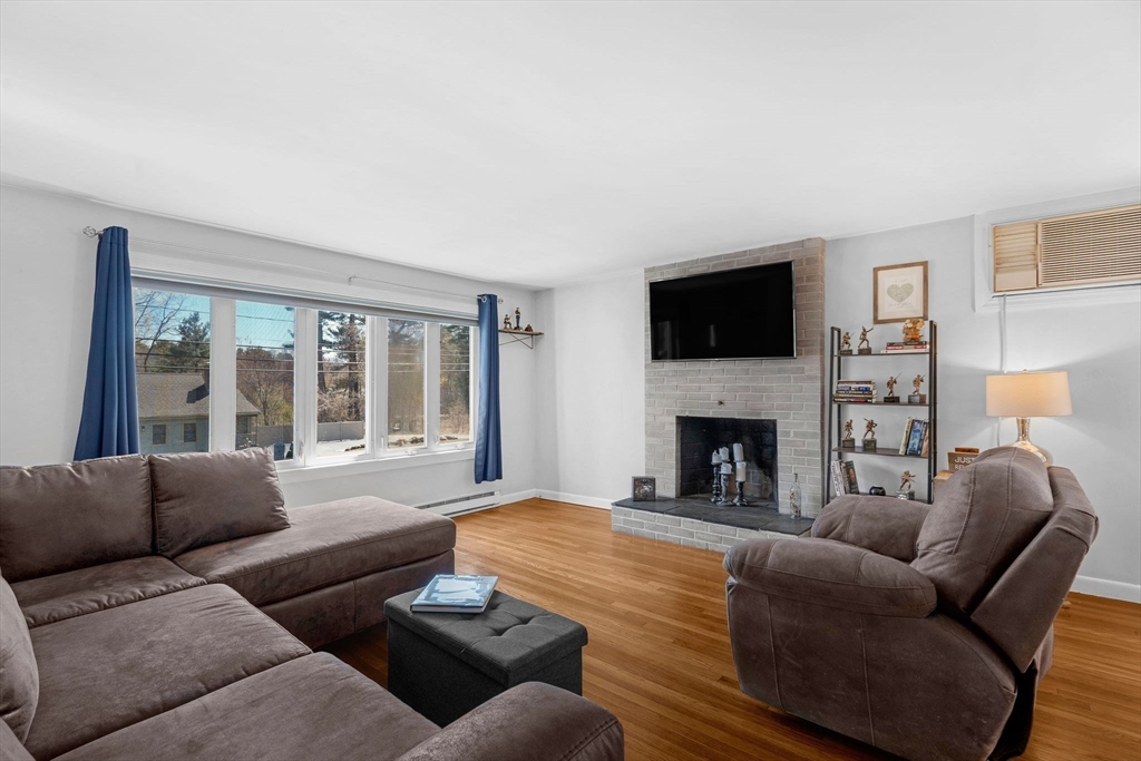156 Andover Road Billerica, MA 01821 - Photo 9 of 22 a living room with furniture a fireplace and a flat screen tv