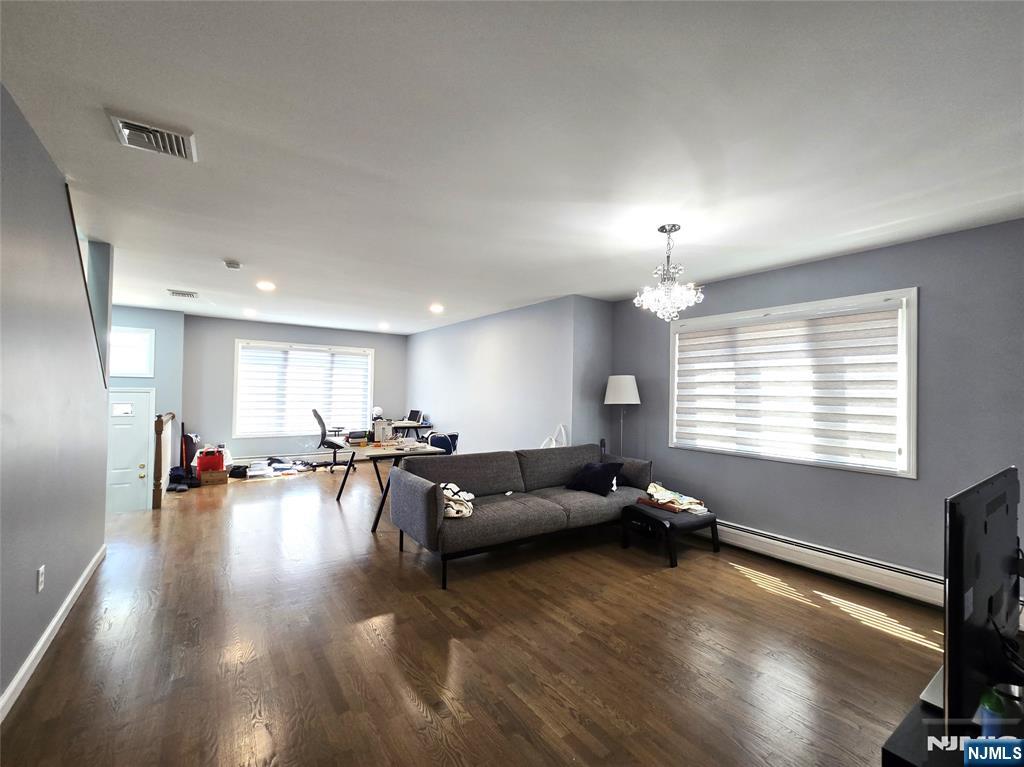 233 Warren Avenue, Unit B Fort Lee, NJ 07024 - Photo 3 of 11 a living room with furniture and a flat screen tv