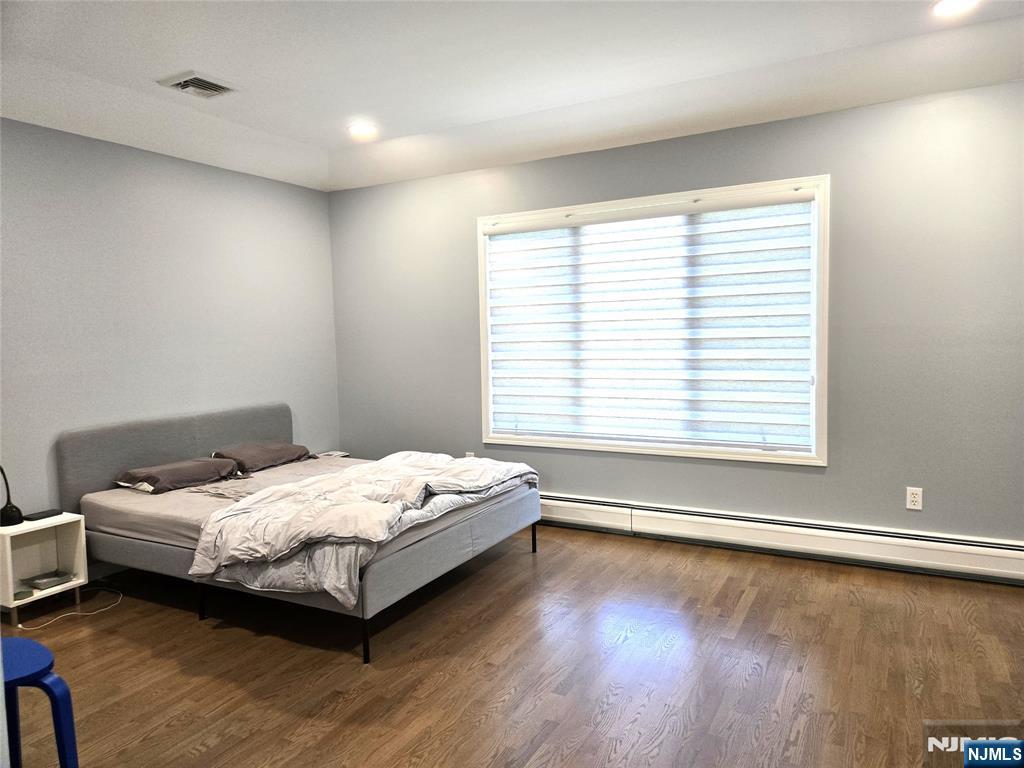 233 Warren Avenue, Unit B Fort Lee, NJ 07024 - Photo 9 of 11 a room with a bed and a window