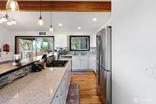 a large white kitchen with a large window