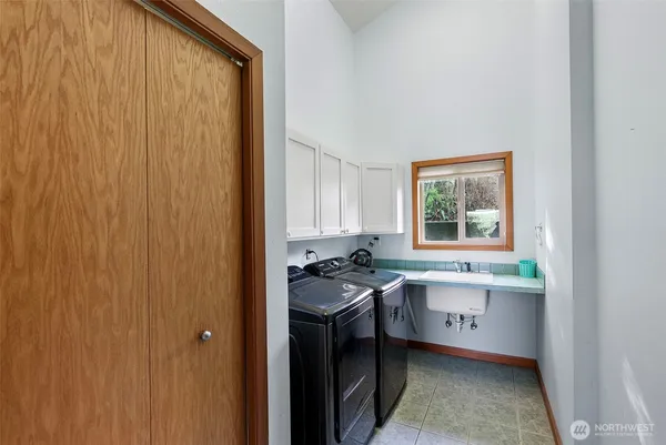 a kitchen with a sink a stove and cabinets