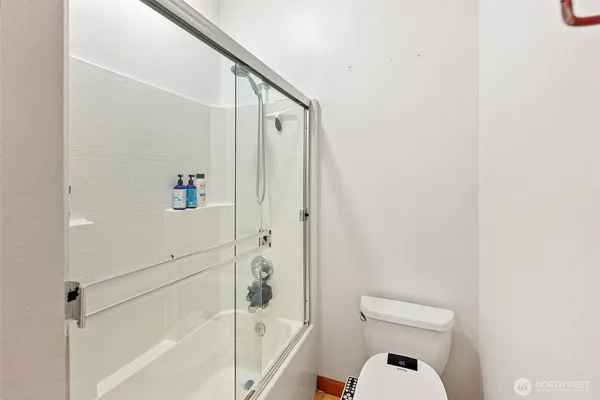a bathroom with a toilet and a shower
