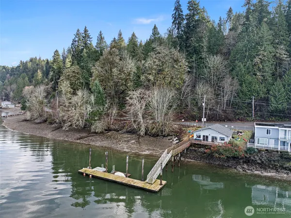 a view of house with large trees and boats