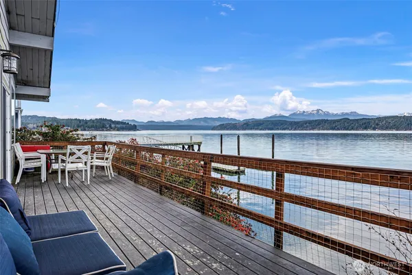 a living room with furniture kitchen view and a large window