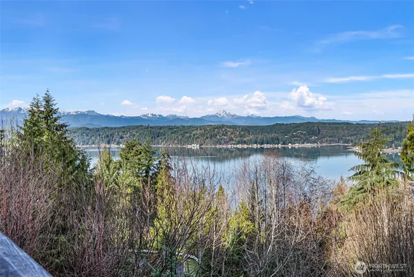 a view of a lake with sunset in the background