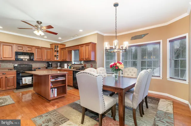 a dining room with furniture a kitchen view