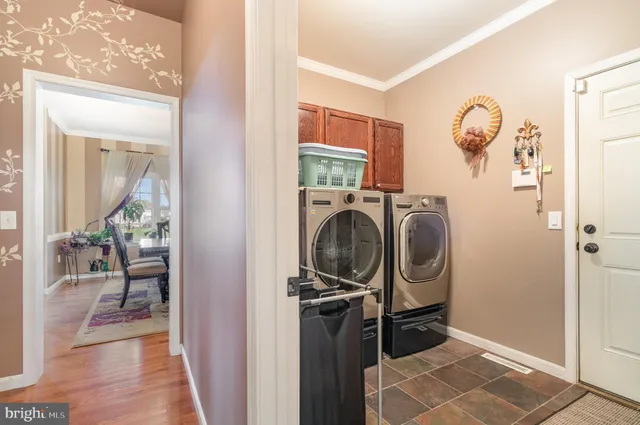a view of a storage and utility room with a washer dryer