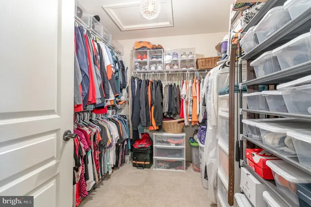 a view of walk in closet with clothes