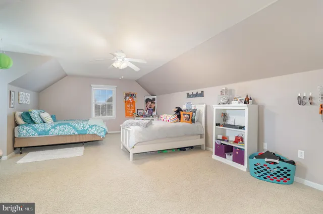 a bedroom with furniture and a baby crib