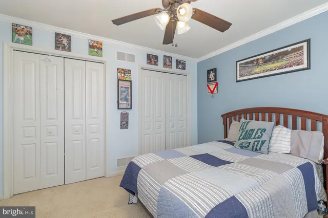 a bedroom with a large bed and a chandelier