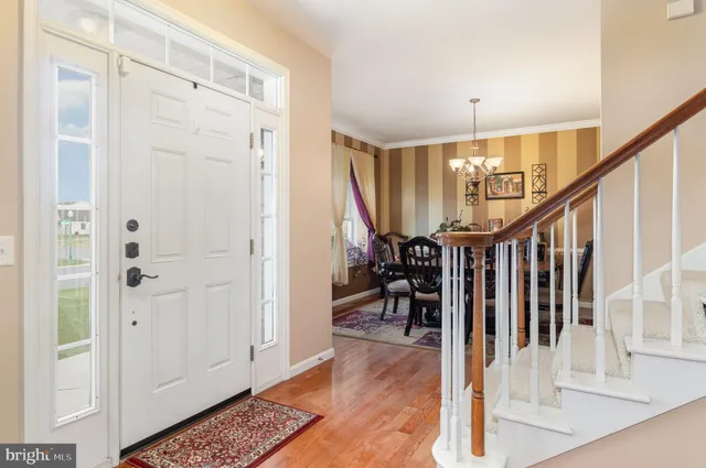 a view of entryway and hall with wooden floor