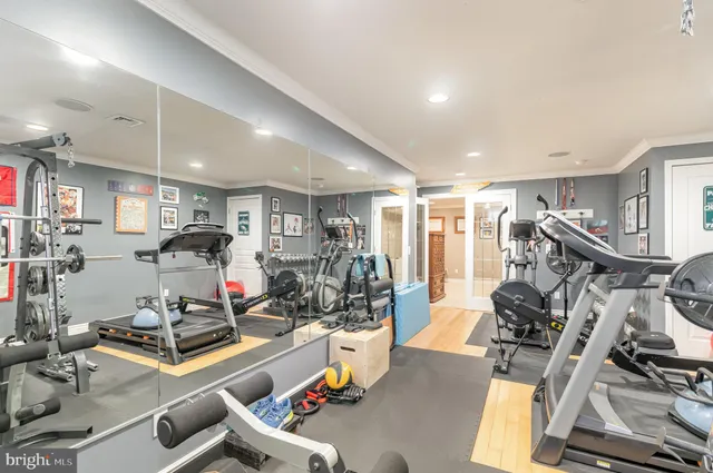 a room with gym equipment and glass door