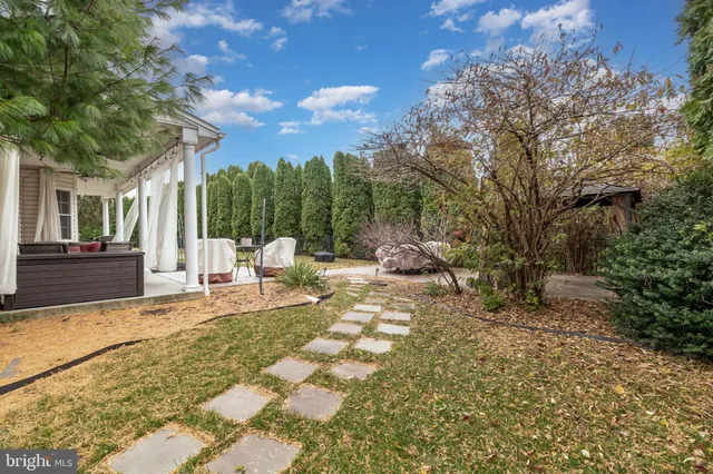 a view of a house with backyard and sitting area