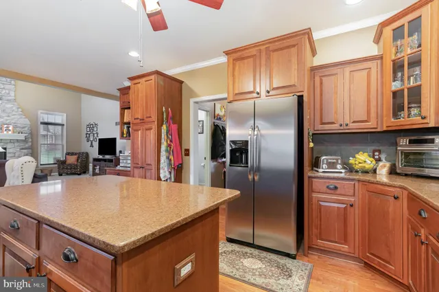 a kitchen with stainless steel appliances granite countertop a refrigerator a sink and dishwasher