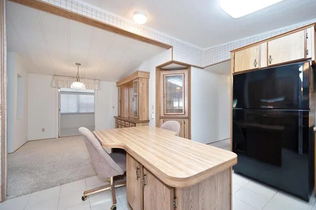 a kitchen with a table chairs refrigerator and microwave