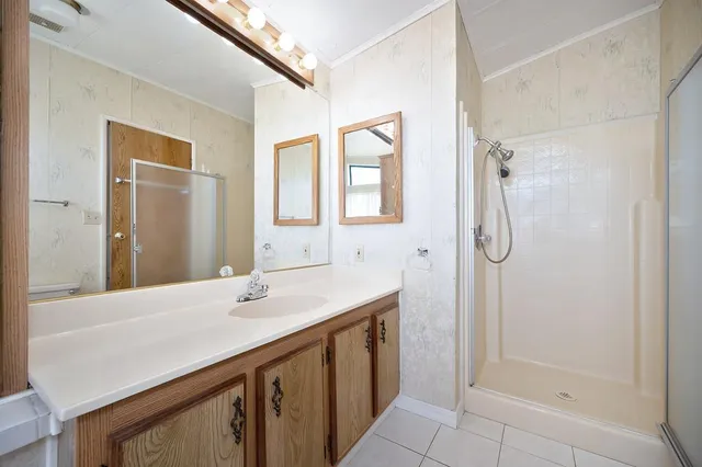 a bathroom with a sink a mirror and a shower