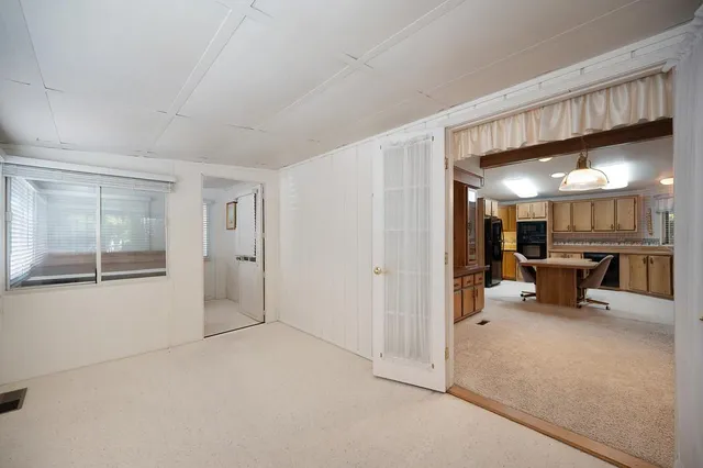 a view of a livingroom with furniture and a ceiling fan
