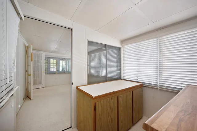 an empty room with windows and closet