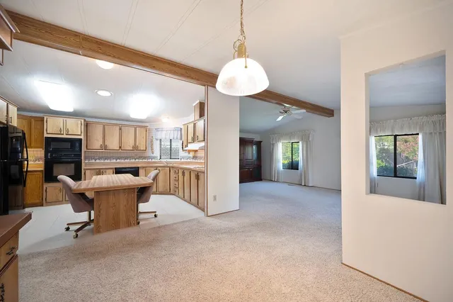 a view of a livingroom with a dining table and chairs