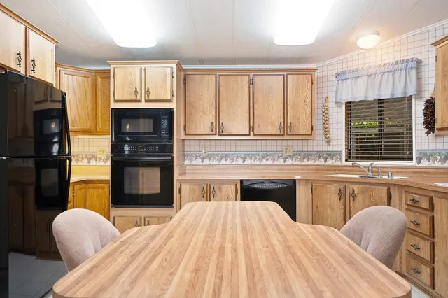 a bedroom with a bed dresser and a large window