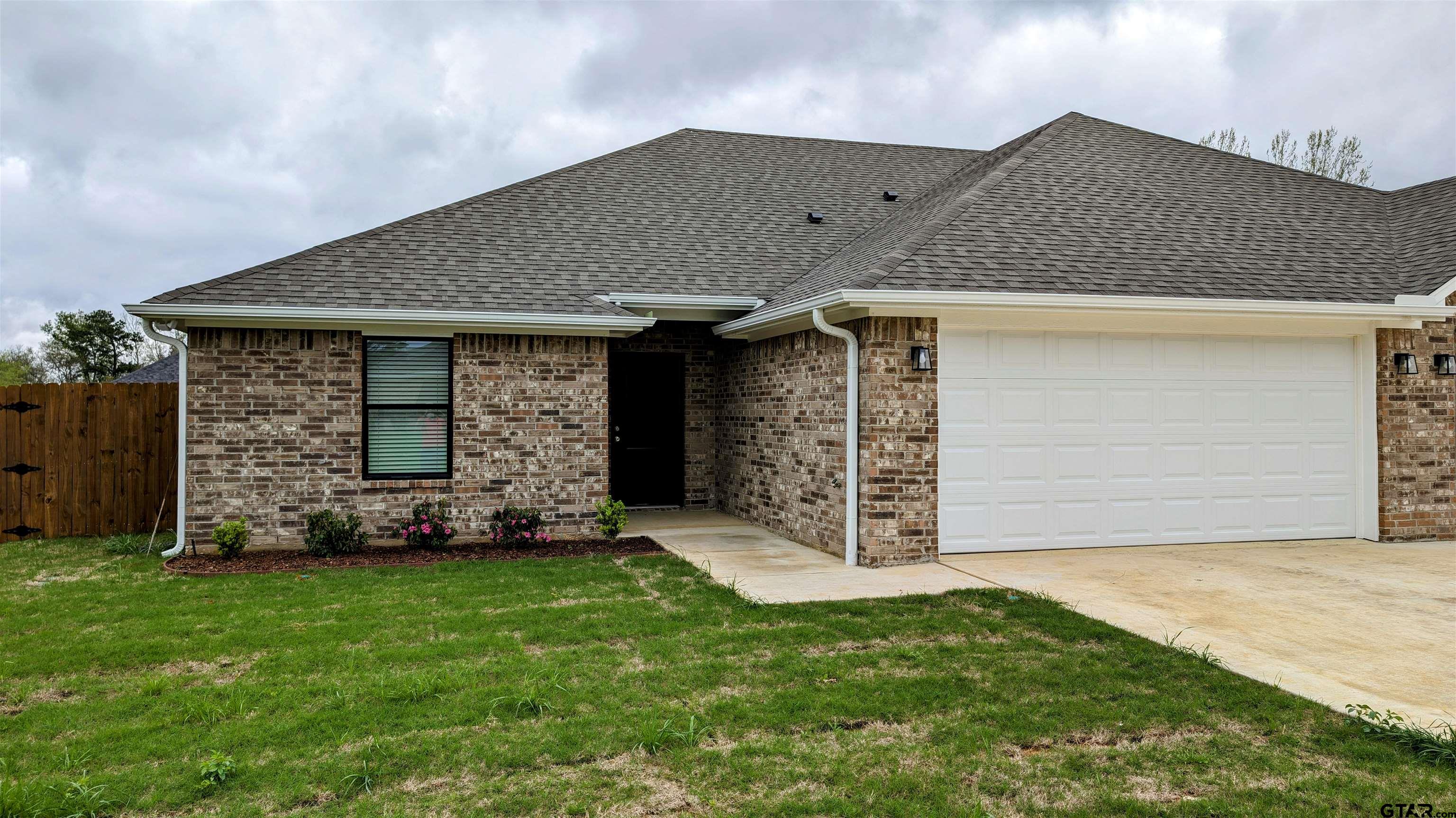 front view of a house with a yard