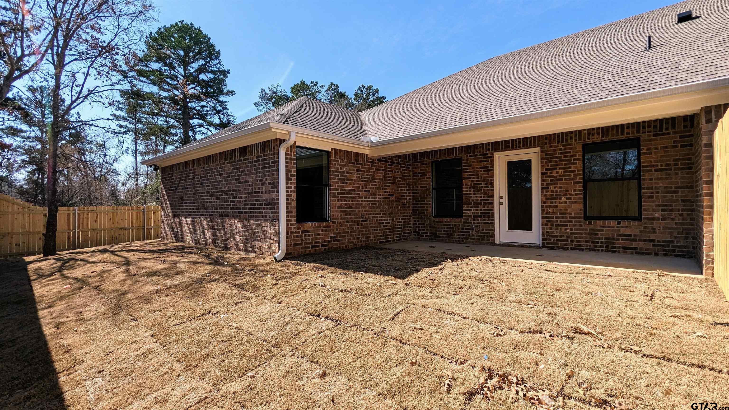 11086 County Road 167, Unit 9 Tyler, TX 75703 - Photo 19 of 20 a front view of a house with a yard