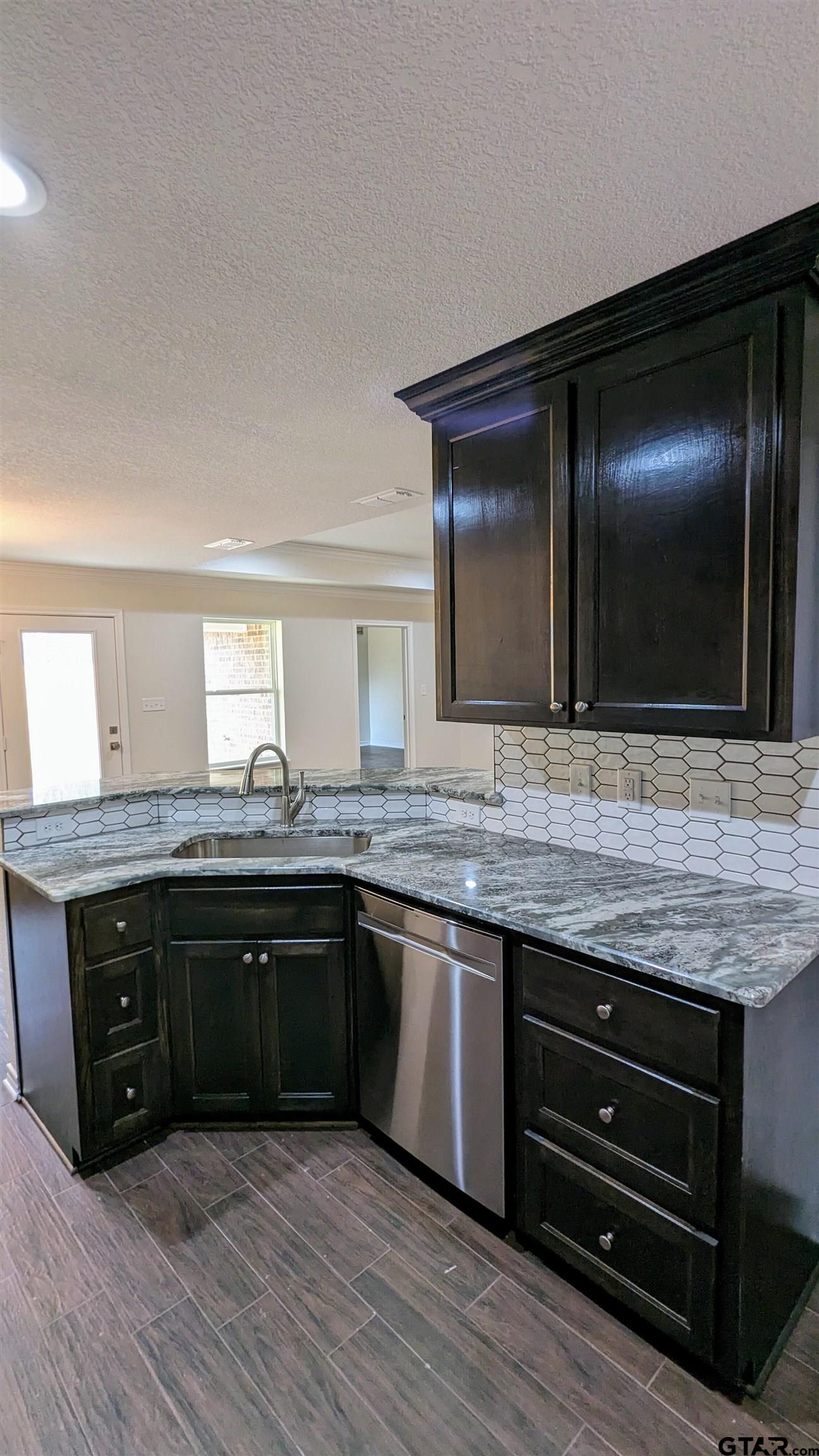 11086 County Road 167, Unit 9 Tyler, TX 75703 - Photo 6 of 20 a spacious bathroom with a granite countertop sink and a mirror