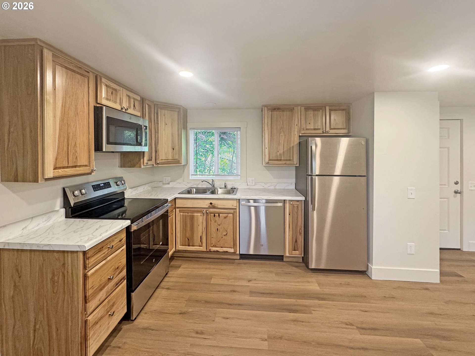 53945 Highway 86 Halfway, OR 97834 - Photo 35 of 48 a kitchen with a refrigerator a stove top oven a sink and dishwasher with wooden floor
