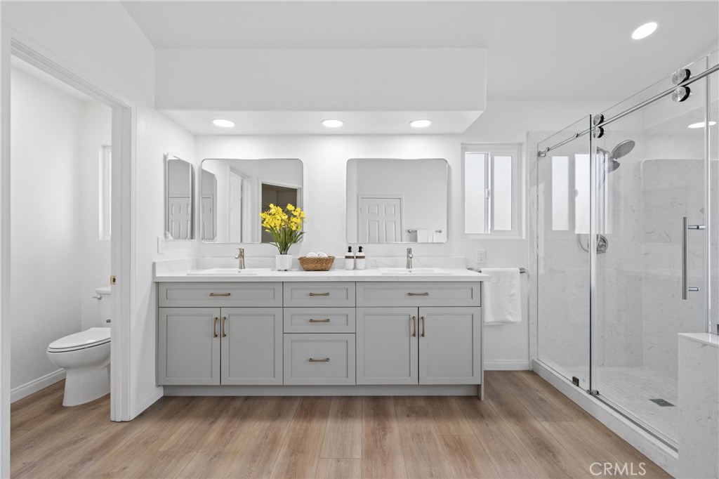 21111 Stockton Pass Road Walnut, CA 91789 - Photo 18 of 33 a spacious bathroom with a double vanity sink a toilet and a shower