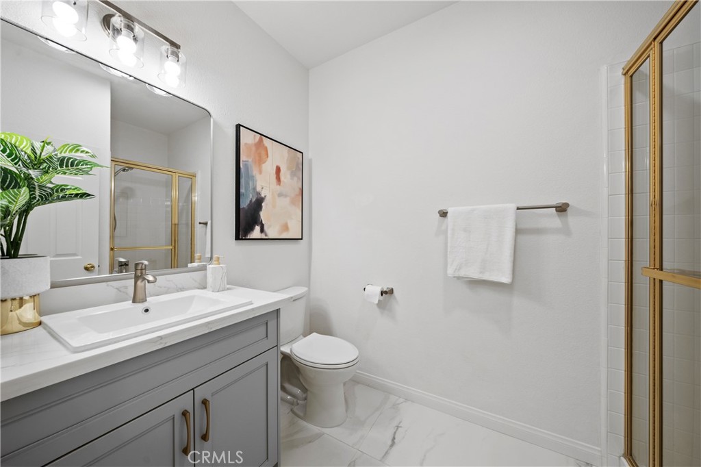 21111 Stockton Pass Road Walnut, CA 91789 - Photo 20 of 33 a bathroom with a toilet sink and mirror