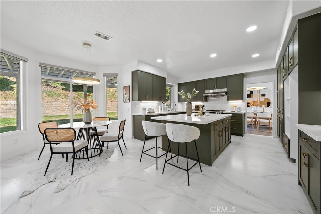21111 Stockton Pass Road Walnut, CA 91789 - Photo 8 of 33 a kitchen with a dining table chairs and white appliances