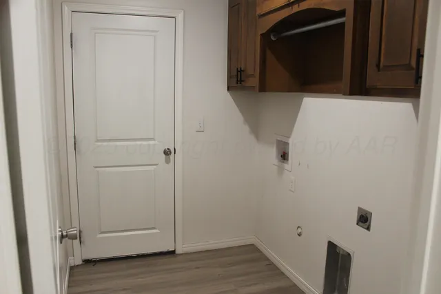 a view of a utility room with wooden floor