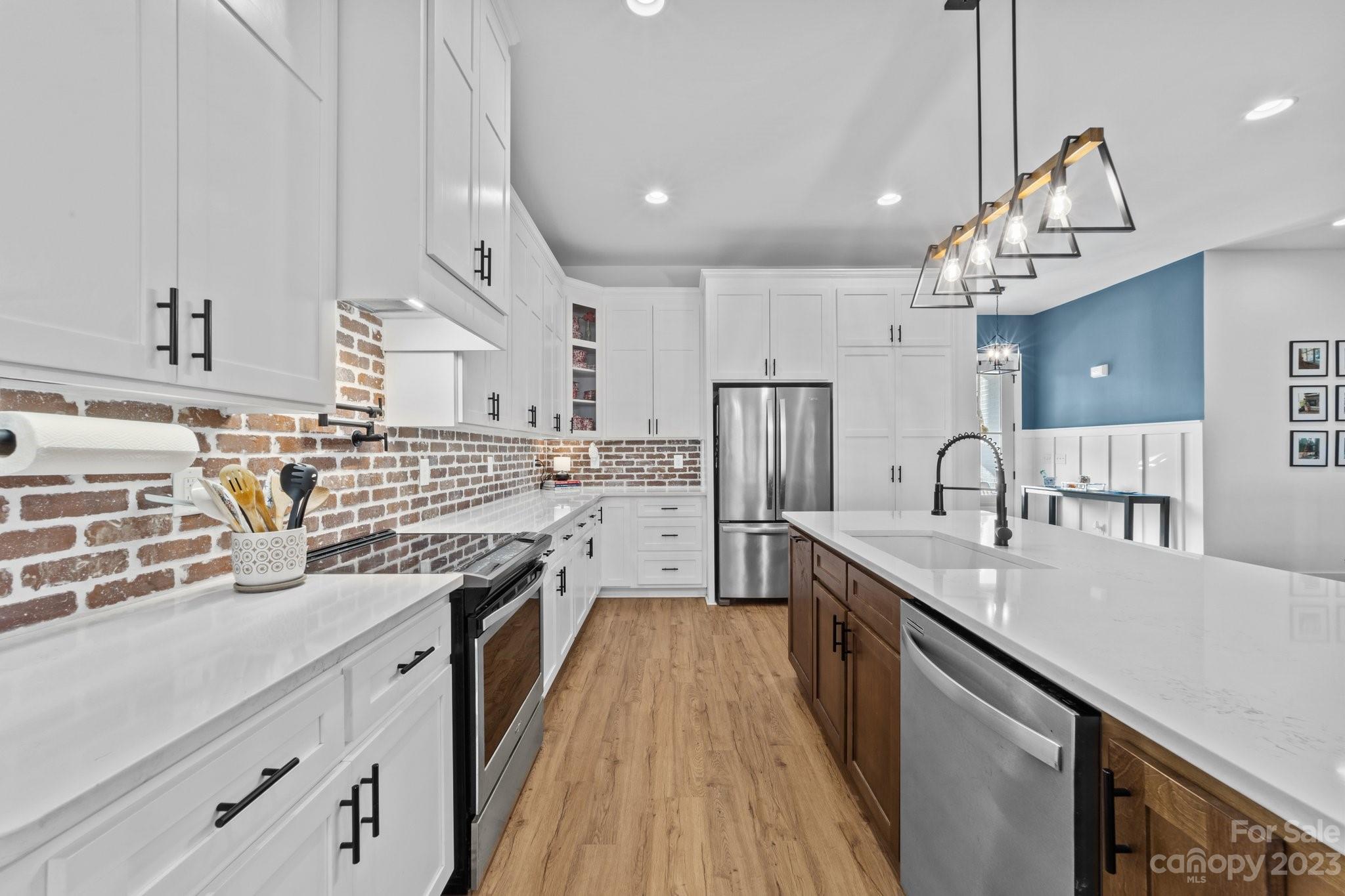 1490 Agner Road Salisbury, NC 28146 - Photo 11 of 47 a large kitchen with stainless steel appliances granite countertop a sink a stove and a refrigerator