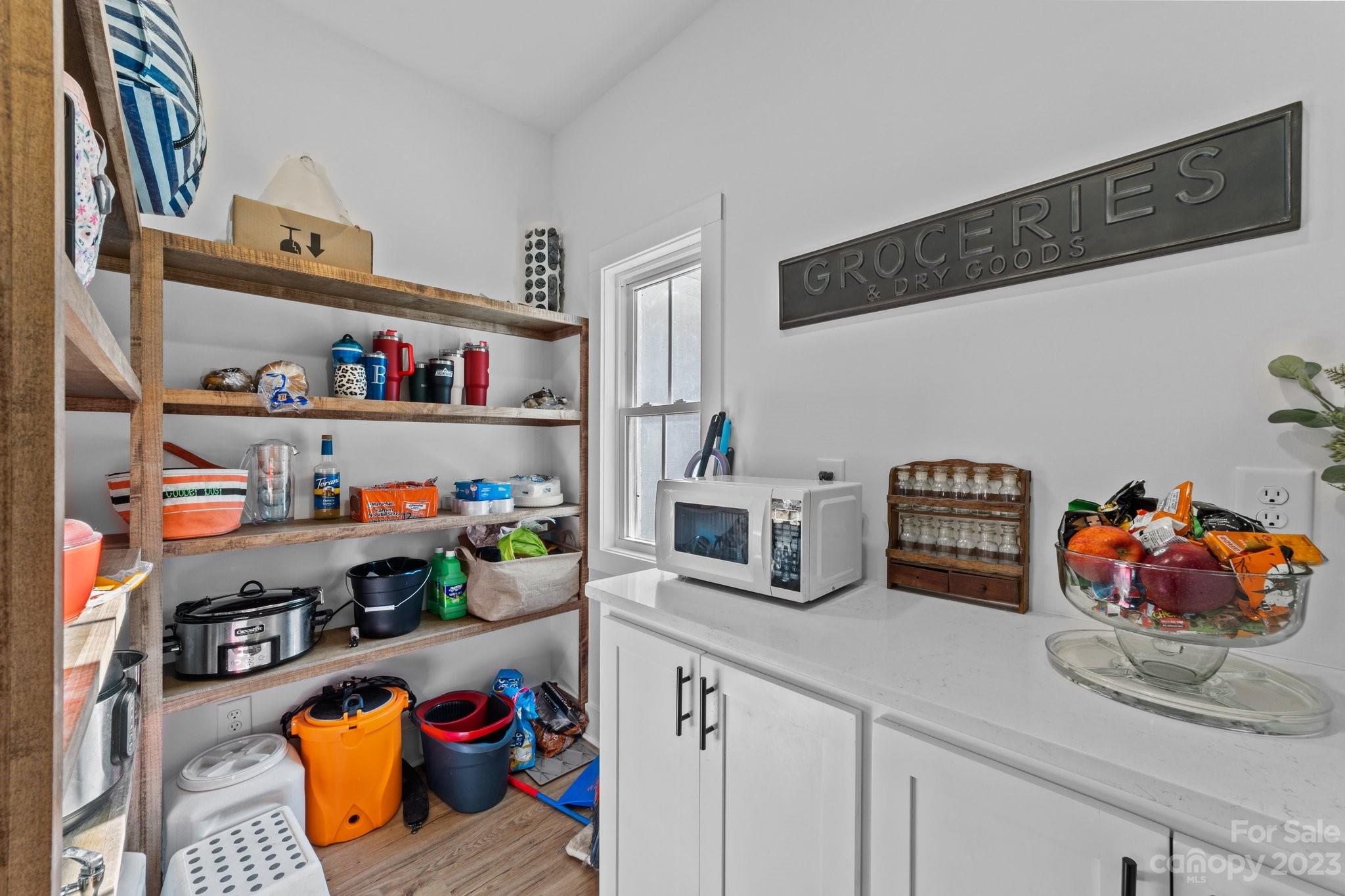 1490 Agner Road Salisbury, NC 28146 - Photo 13 of 47 a kitchen with lots of clutter and white cabinets