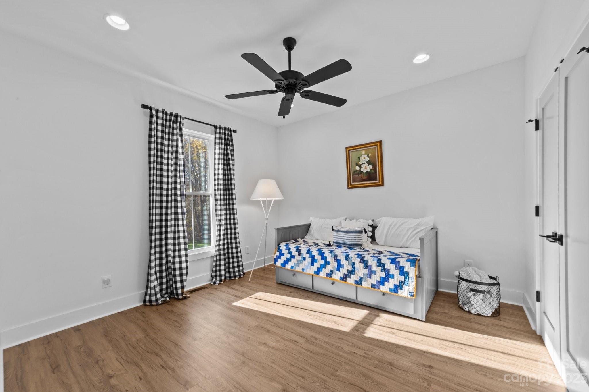 1490 Agner Road Salisbury, NC 28146 - Photo 29 of 47 a view of a hallway with wooden floor and a ceiling fan