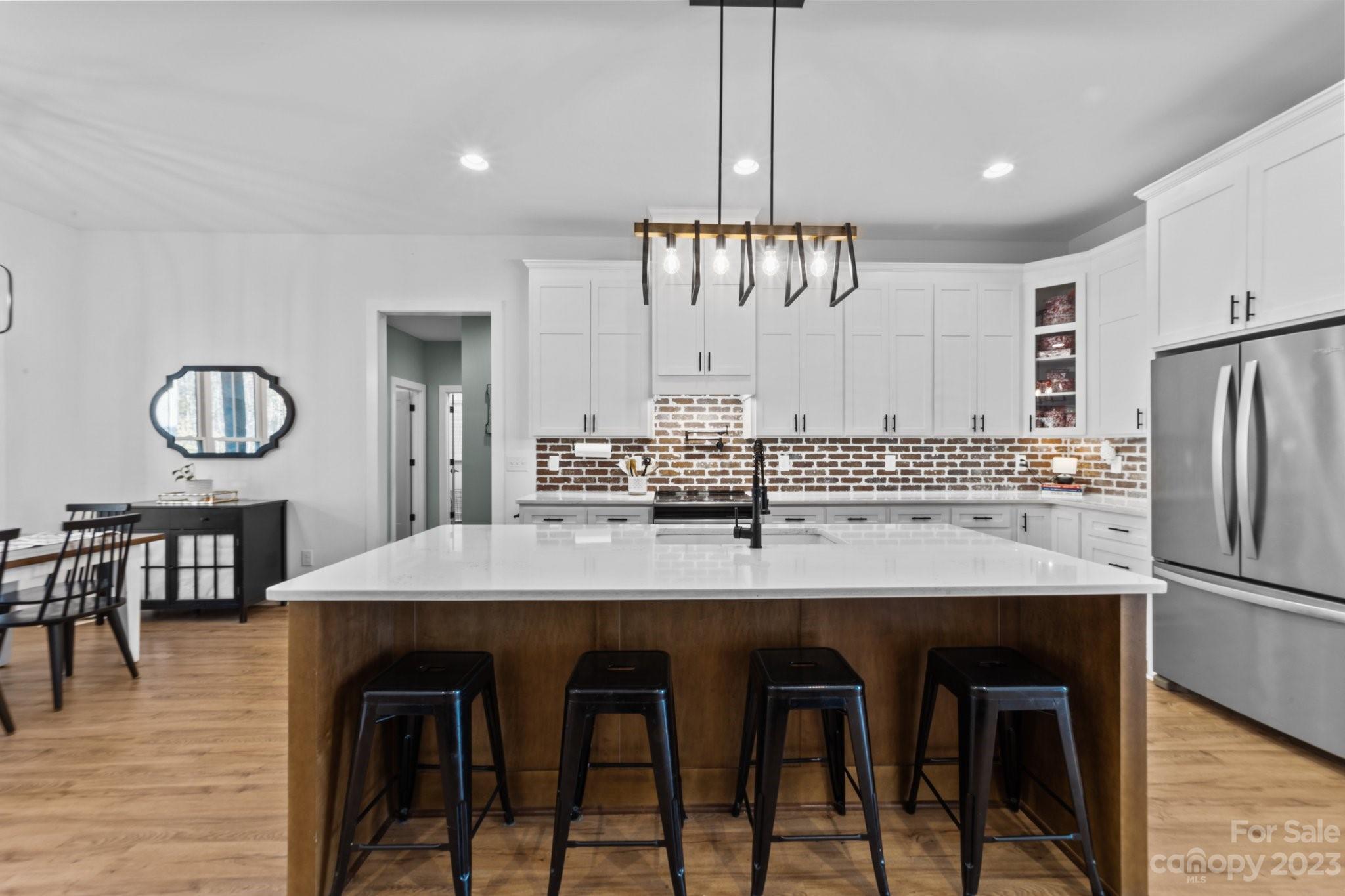 1490 Agner Road Salisbury, NC 28146 - Photo 10 of 47 a kitchen with stainless steel appliances kitchen island a table chairs and a refrigerator