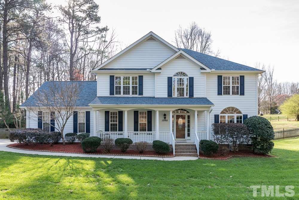 12708 Norwood Road Raleigh, NC 27613 - Photo 1 of 24 a front view of a house with a garden and yard