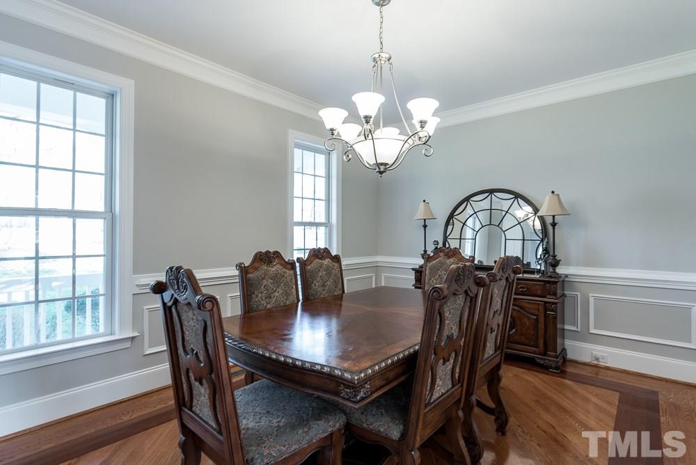 12708 Norwood Road Raleigh, NC 27613 - Photo 4 of 24 a view of a dining room with furniture window and wooden floor