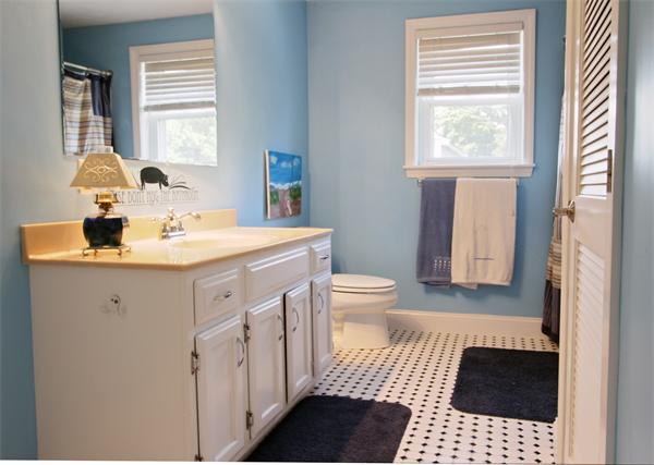 10 Cliff Estates Road, Unit 10 Scituate, MA 02066 - Photo 15 of 26 a bathroom with a sink toilet a mirror and next to a window