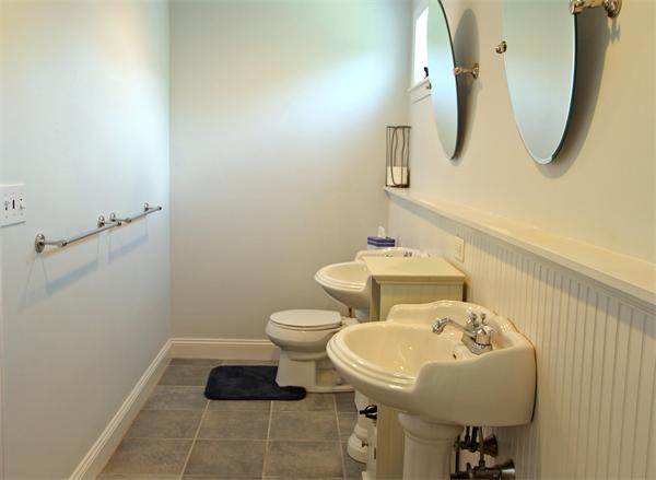 10 Cliff Estates Road, Unit 10 Scituate, MA 02066 - Photo 17 of 26 a bathroom with a sink a toilet and mirror